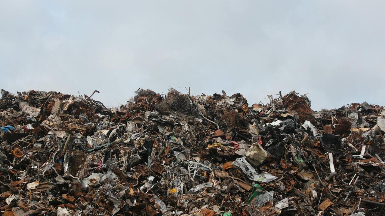 Waste dumpsite under clear sky
